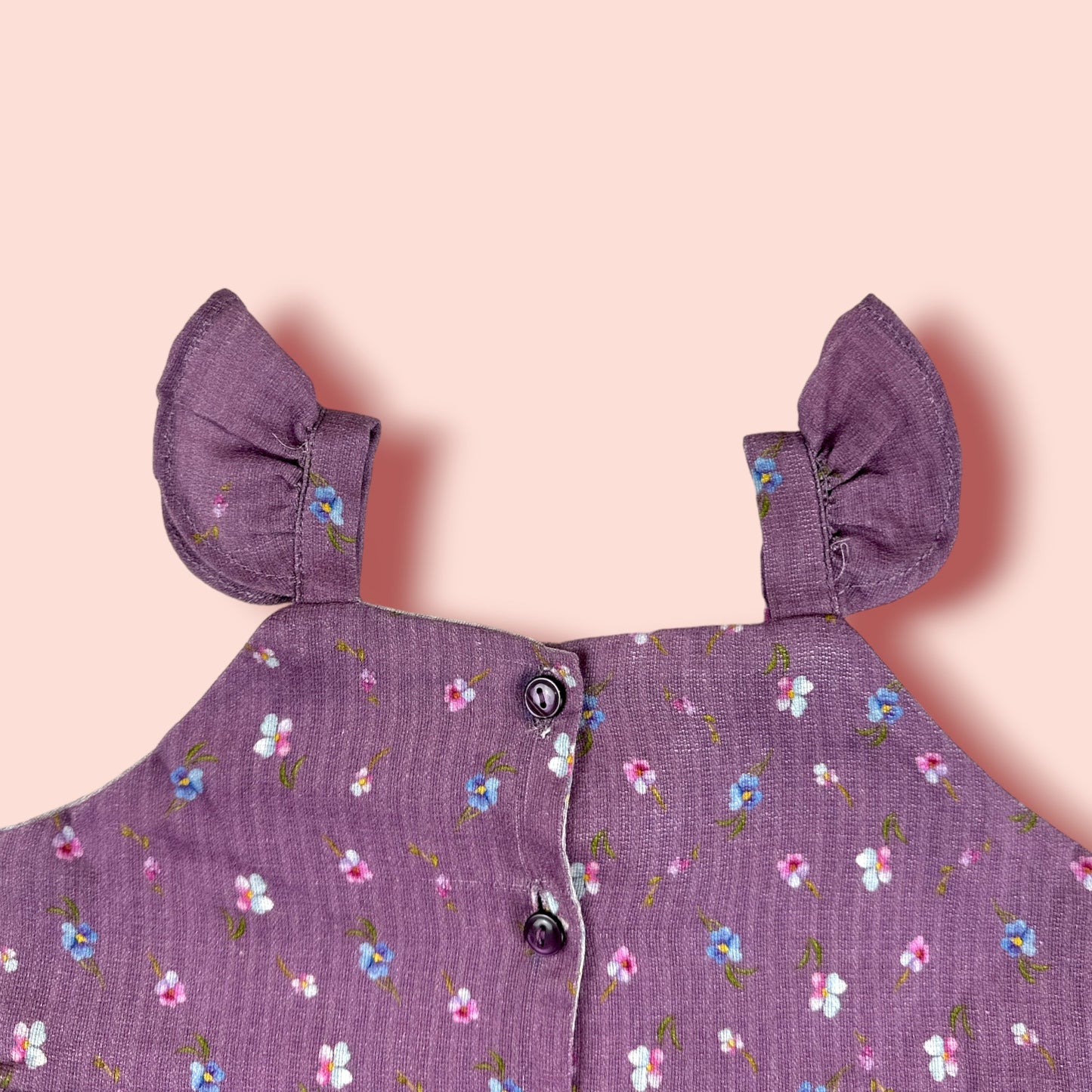 neck view of The Purple Floral Lawn Frock is printed with purple flowers