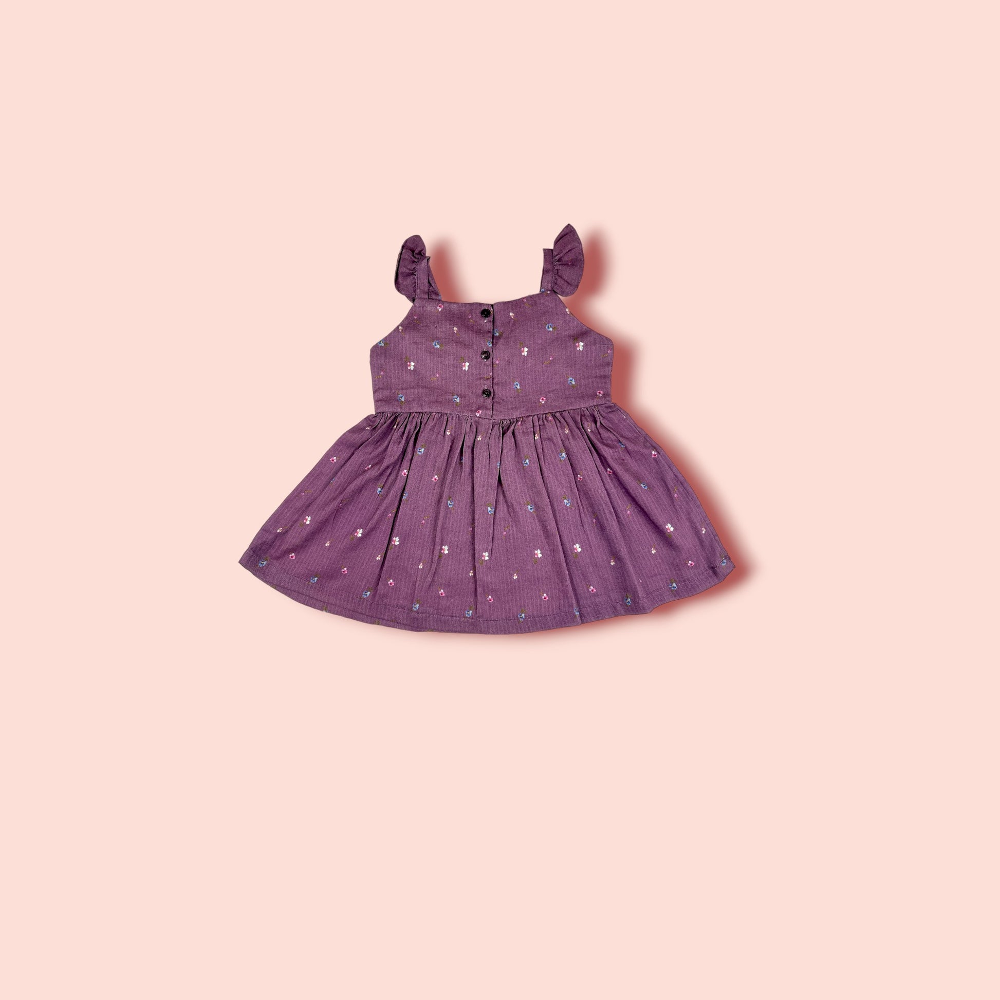 full view of The Purple Floral Lawn Frock is printed with purple flowers